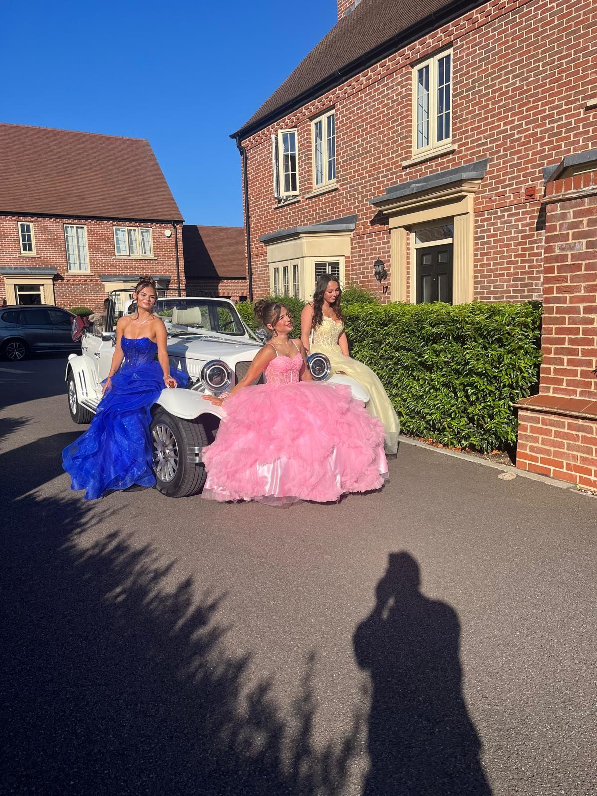 Prom guests in gowns with the Beauford vintage tourer — Bedford Executive Cars