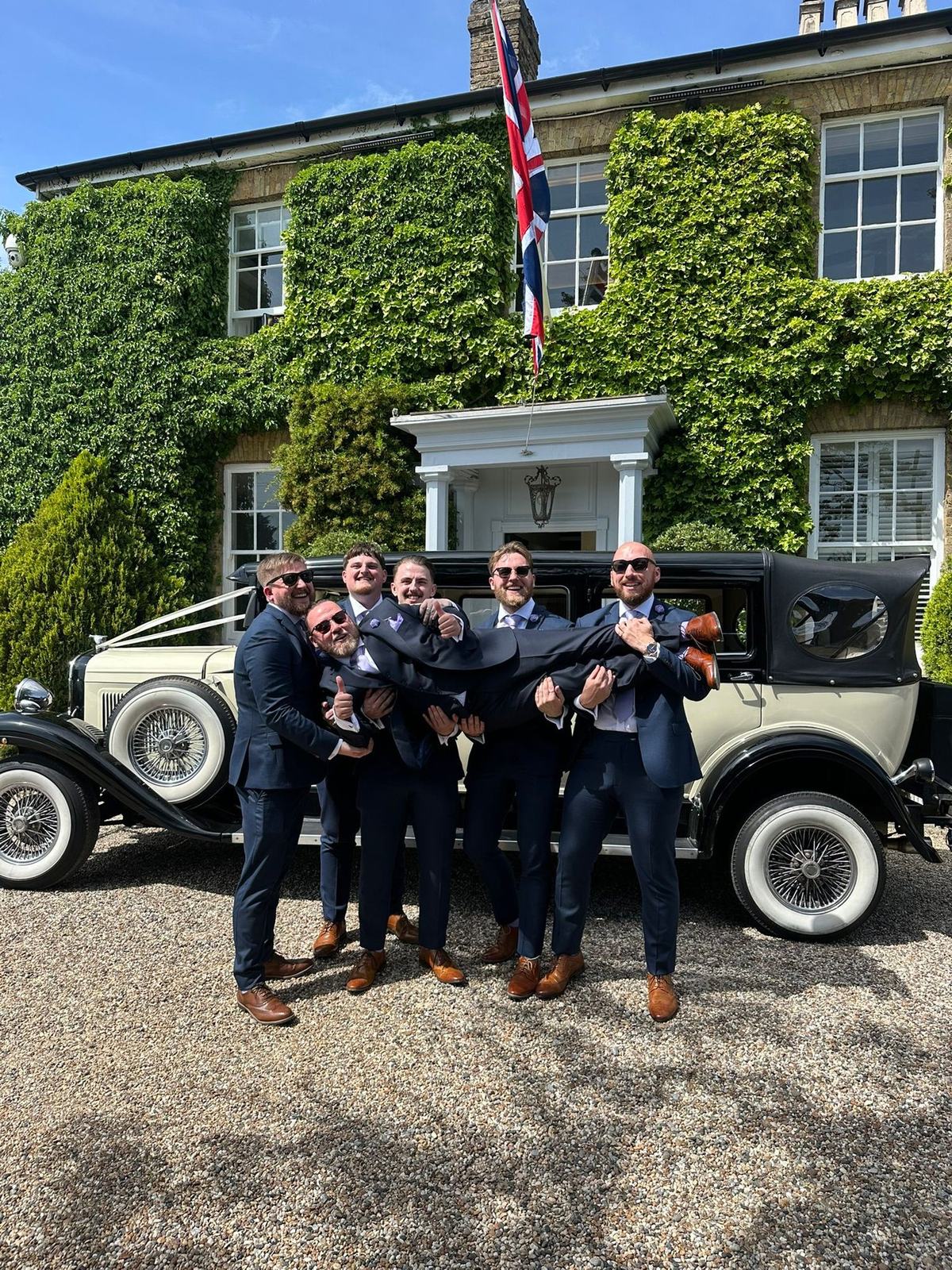 Couple with white Rolls-Royce Phantom at rustic barn venue
